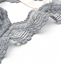 Cargar imagen en el visor de la galería, Close-up of silver lace fabric with text &#39;Fancy Lace Soft and non-tacky&#39; on a white background
